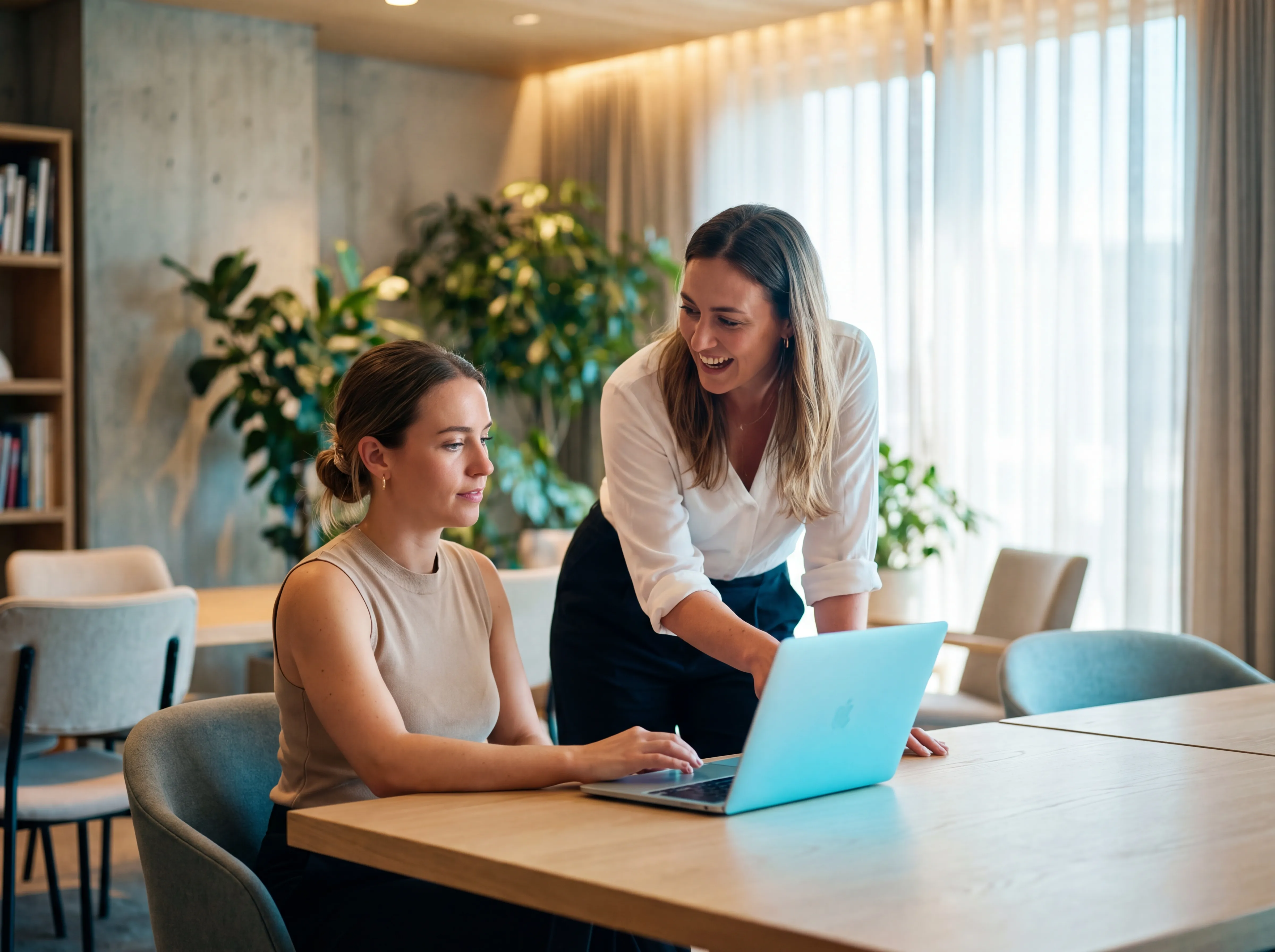Two women collaborating in office
